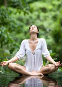 woman doing yoga meditation to lower blood pressure
